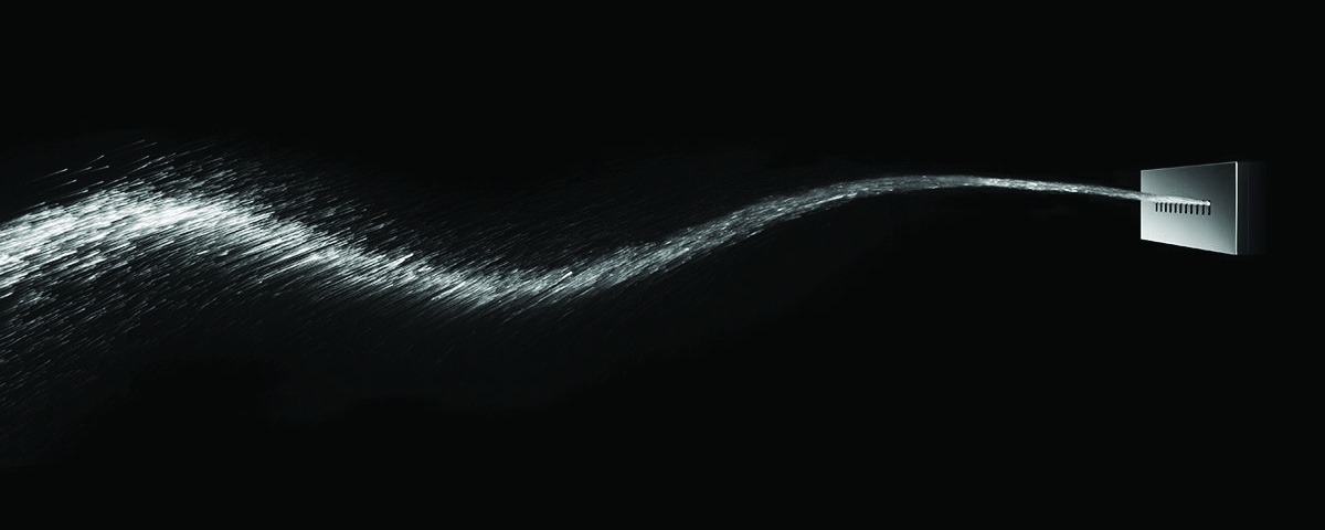 Wave Jet projecting a long curving sheet of water across a dark interior